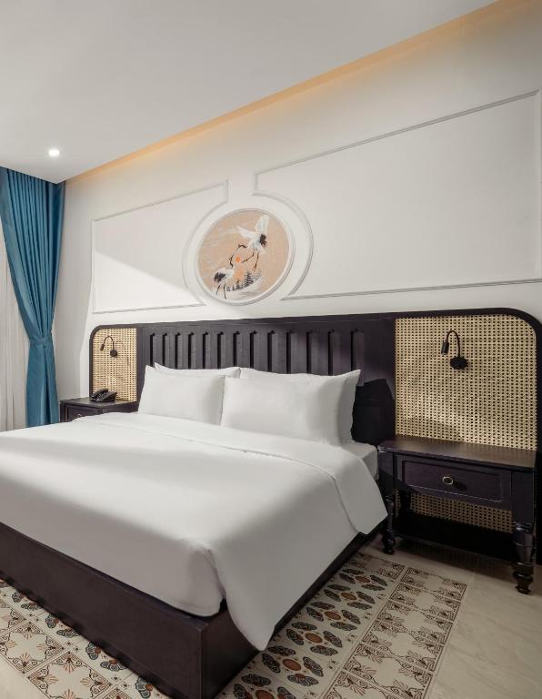Giường trong phòng chung tại ELC Boutique Hoi An Hotel