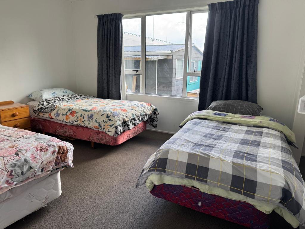 Postel nebo postele na pokoji v ubytování Mount Maunganui House