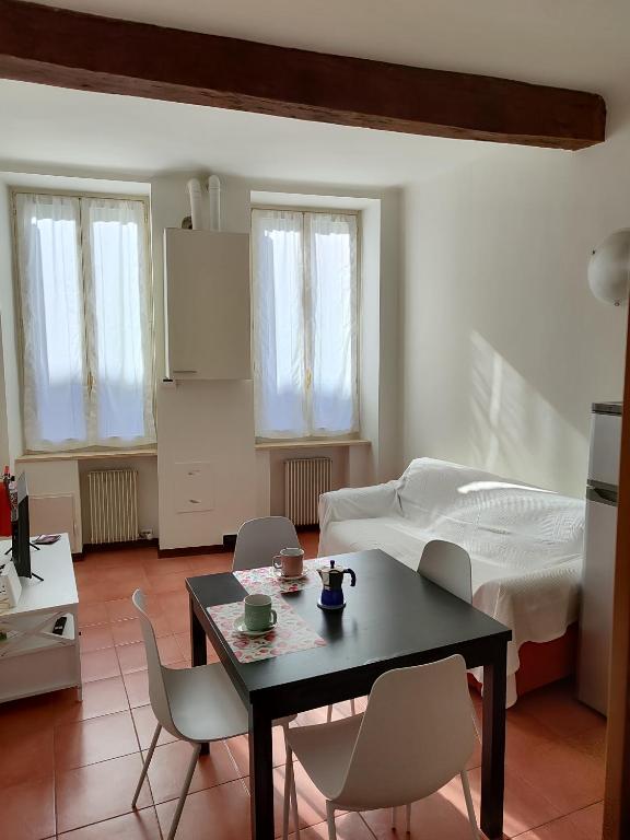 a living room with a table and chairs and a bed at A casa di Raffaella in Parma
