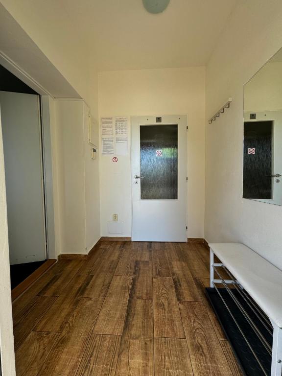 an empty room with a wooden floor and a door at MiniPenzion Na Vyhlídce in Olomouc