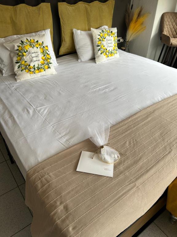 a large bed with a white comforter and pillows at Amaryllis apartment 23 in Serres