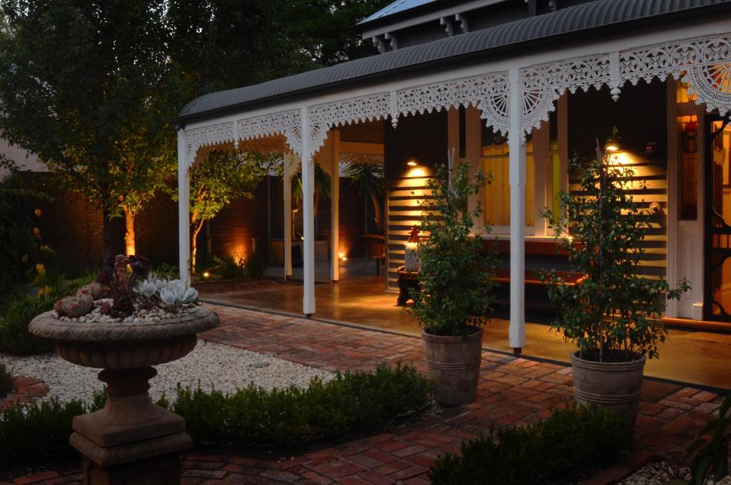 a large outdoor patio with a fire place in front of it at Clement House in Benalla