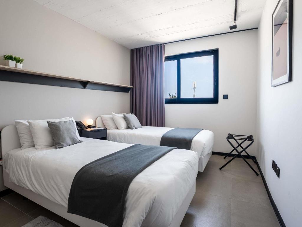 Postel nebo postele na pokoji v ubytování Aparthotel Adagio Malta Central