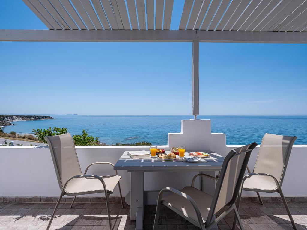 a table and chairs with a view of the ocean at Anthos in Frangokastello