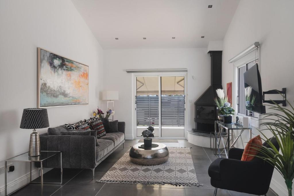 a living room with a couch and a table at Botanical Art House by Staycom in Paphos City