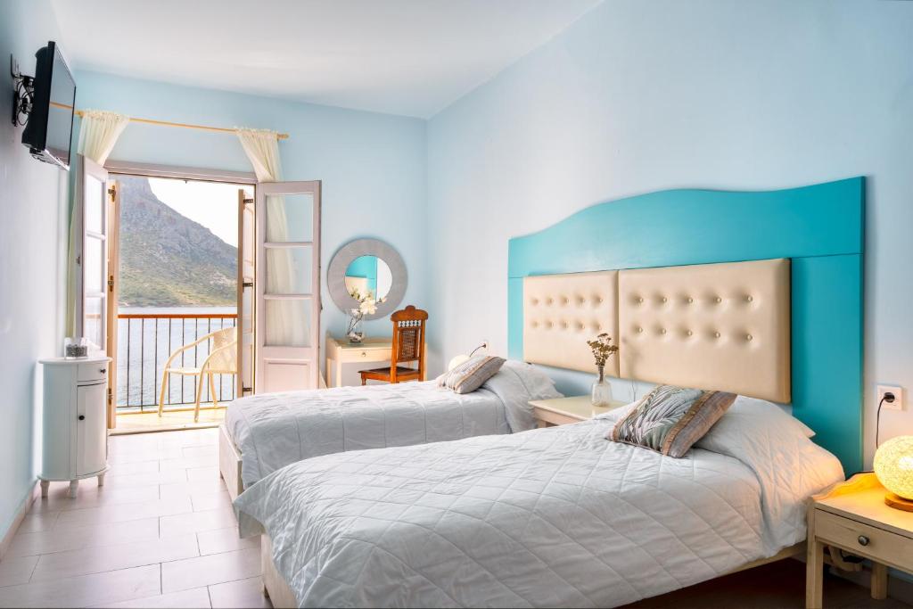 Postel nebo postele na pokoji v ubytování MasouriBlu Boutique Hotel