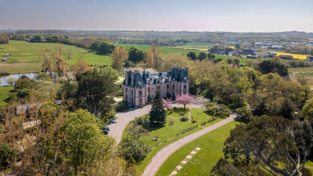 an aerial view of a mansion in a field at Château Hôtel Du Colombier in Saint Malo