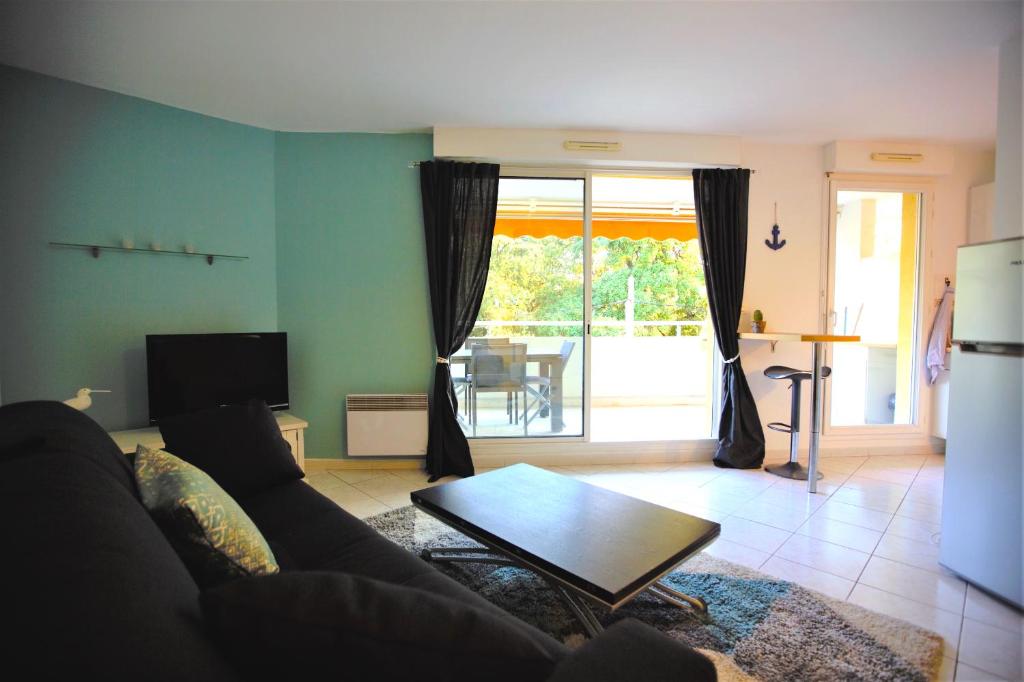 un salon avec un canapé et une table dans l'établissement La Ciotat Mer Charmant Studio avec Grande Terrasse, à La Ciotat