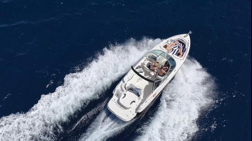 a white boat in the water with people in it at Mallorcainblue Charter in Port d'Alcudia