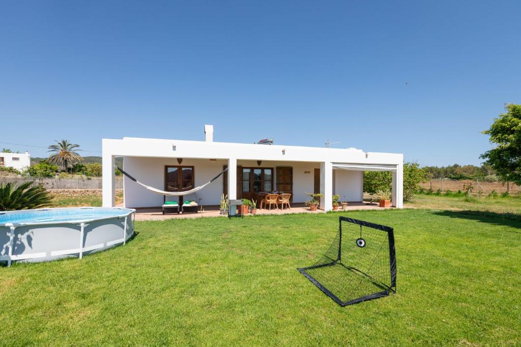 a house with a hammock in a yard at New! Villa Cana Vane in Puerto de San Miguel
