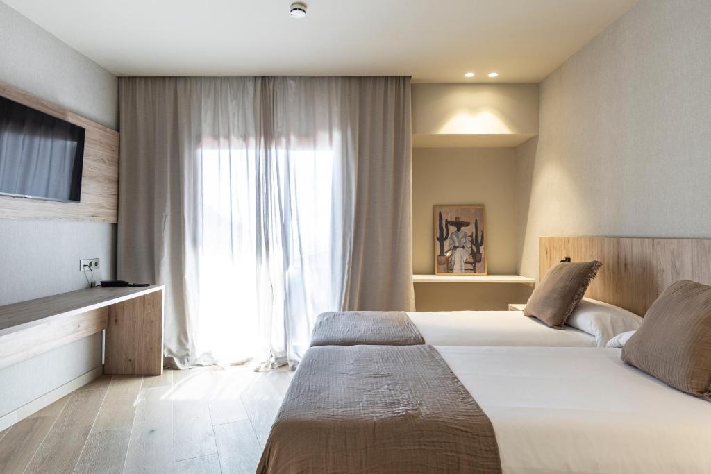 Posteľ alebo postele v izbe v ubytovaní Hotel Casamar