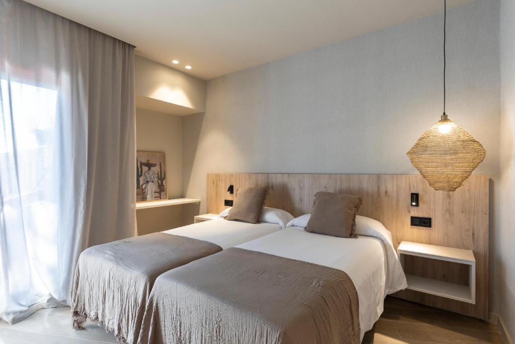 Posteľ alebo postele v izbe v ubytovaní Hotel Casamar