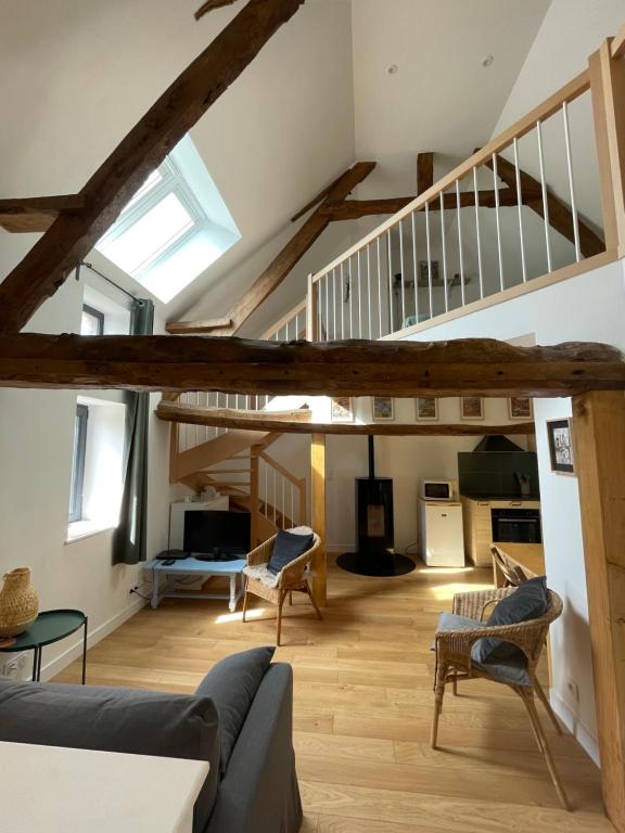 a living room with a loft with a staircase at Peaceful countryside loft in Saonnet