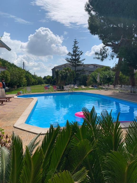 a large swimming pool with blue water at Villa Preveza Apartments in Preveza