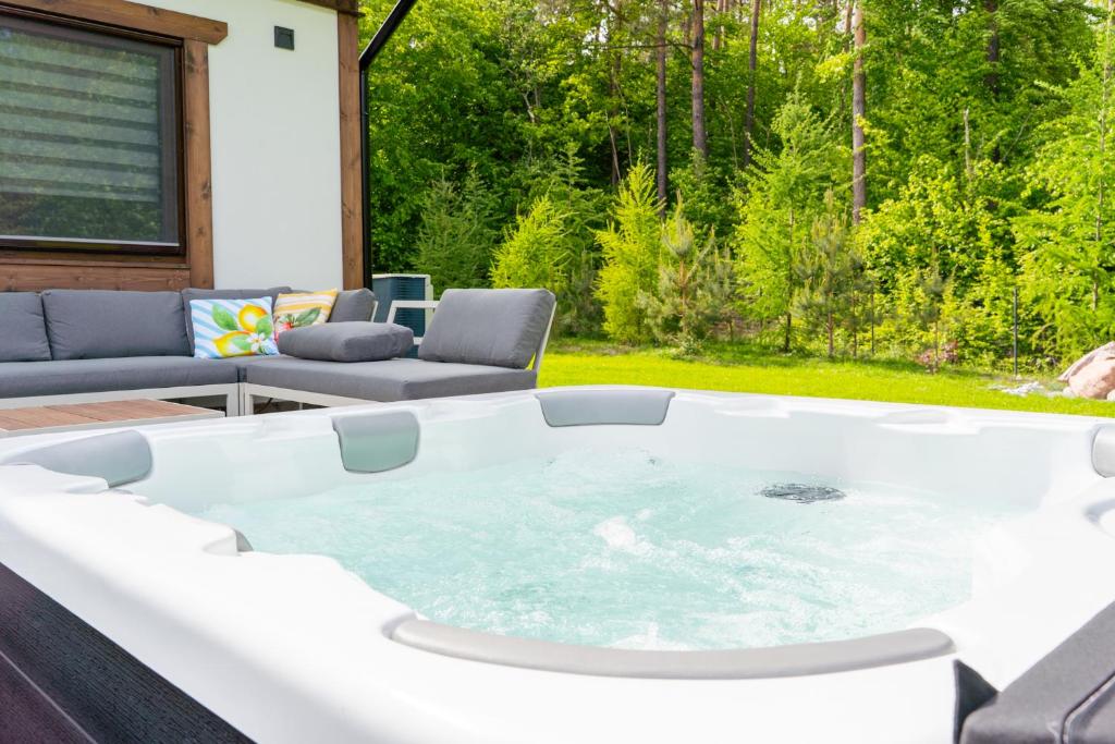 a hot tub in the middle of a patio at Kaszubska Nirvana - całoroczny dom na wyłączność z jacuzzi in Stare Czaple