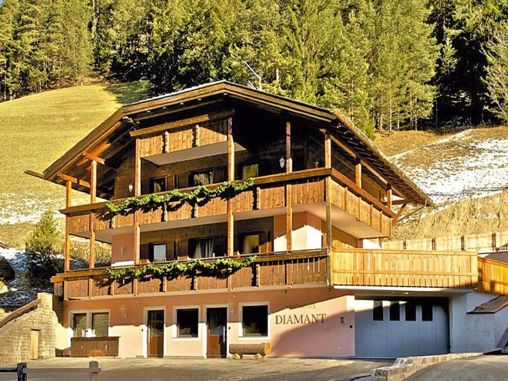 a large wooden building with a large balcony at Amazing apartment house Diamant with breathtaking view in Santa Cristina in Val Gardena