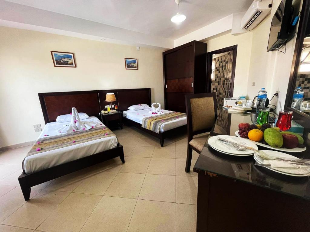 Postel nebo postele na pokoji v ubytování Naama Inn Hotel