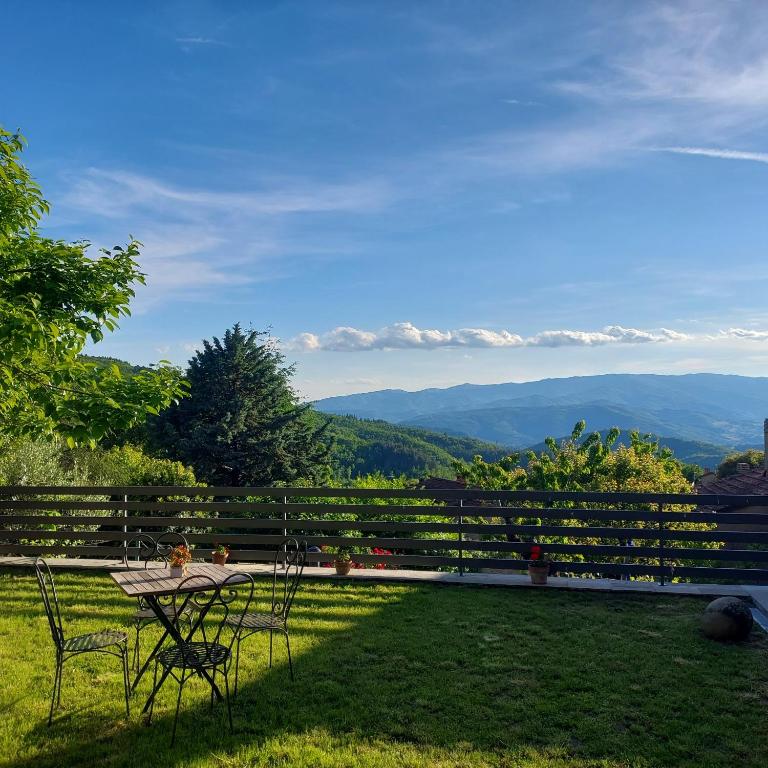 a table and chairs on a patio with a view of mountains at Dama35 - Tuscany holiday house - Casentino-La Verna in La Verna