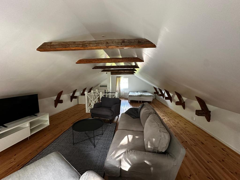 a living room with a couch and a tv at Sörbyvägen 6 in Floby