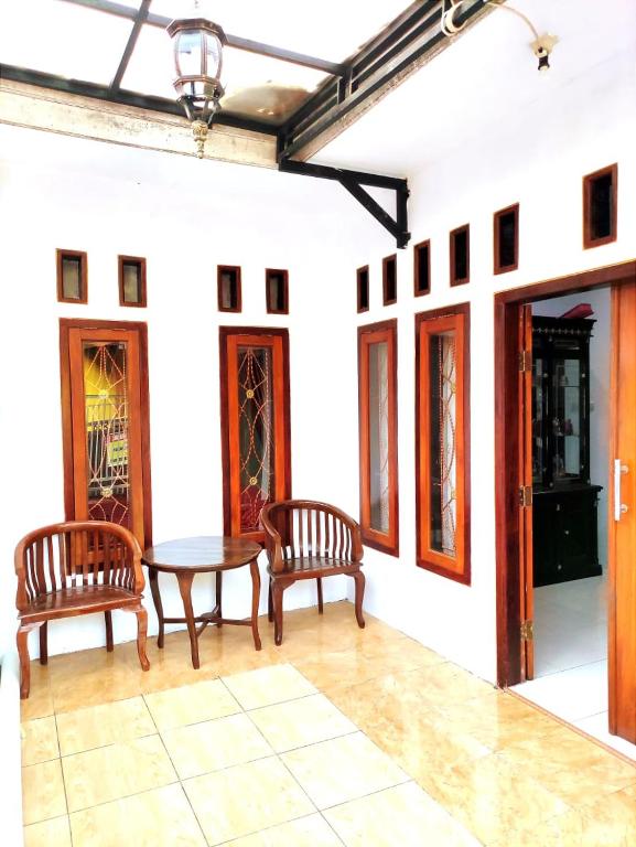 a dining room with two chairs and a table at Denisa homestay Kuningan 2 in Mantaak