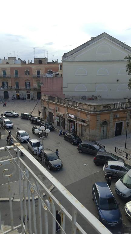 a parking lot with cars parked in front of buildings at b&b TEATRO in Bisceglie