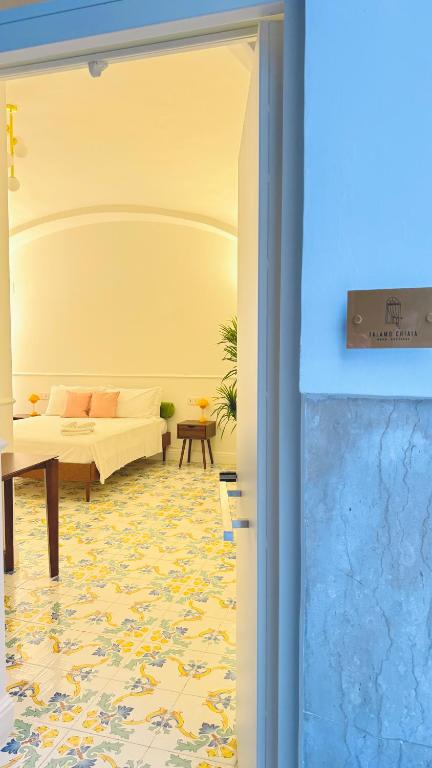 a living room with a couch and a table at Talamo Room Boutique in Naples
