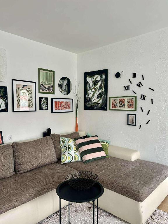 a living room with a couch and pictures on the wall at Your Place in Tallinn - newly renovated! in Tallinn