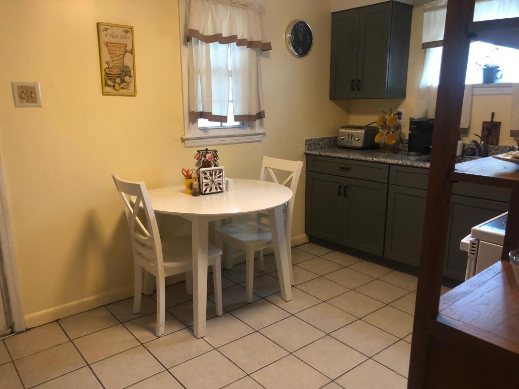 a kitchen with a small white table and chairs at Quiet Harrisburg home in Harrisburg