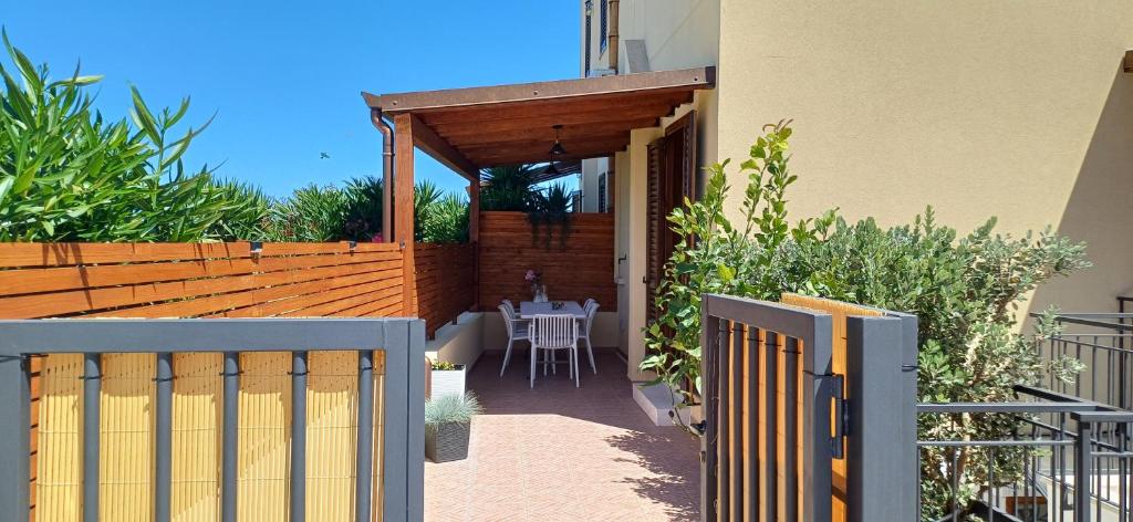 a patio with a table and a wooden fence at Il Mare nel Cuore in Custonaci