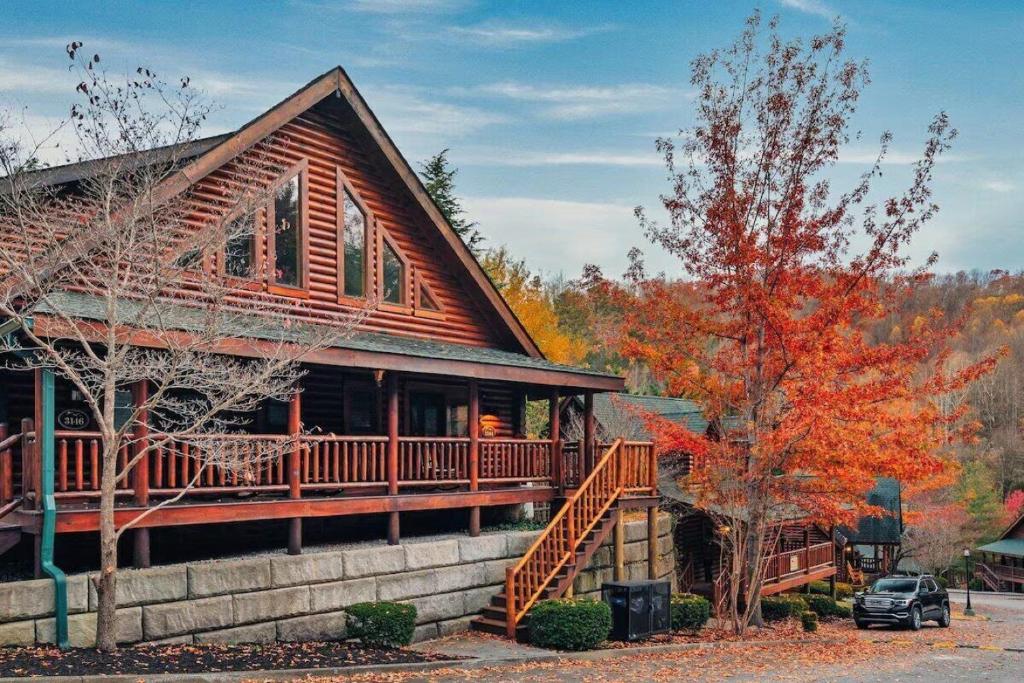 a log home with a deck in the fall at Your Getaway Oasis in Sevierville