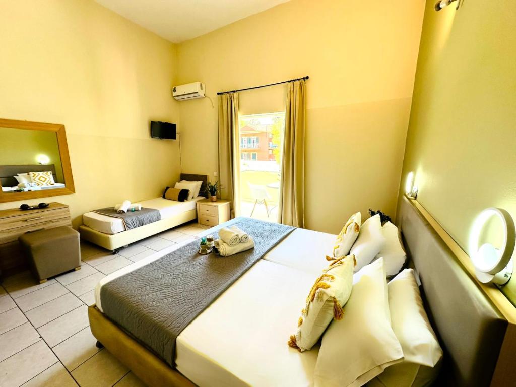 Postel nebo postele na pokoji v ubytování Sidari Vibes Aparthotel