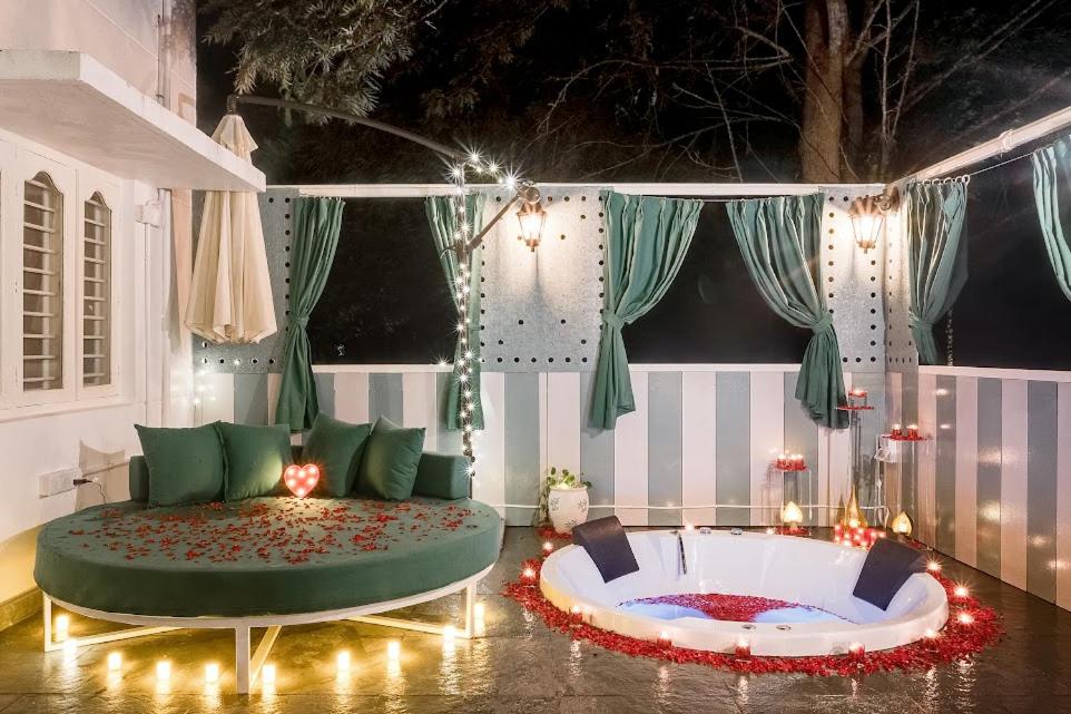 a living room with a large couch and a fire pit at Bangalore Hideaway 1BHK Spanish villa Casa Rio in Denkanikota