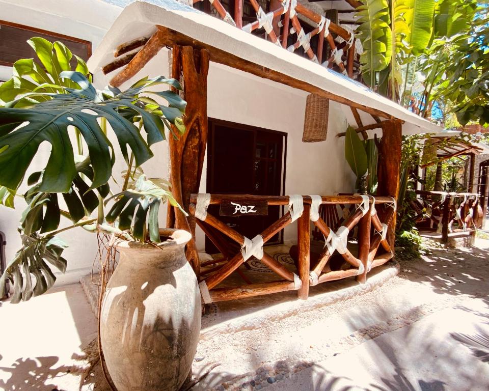 a vase with a plant in front of a house at Hotel Para Ti - Adults Only in Holbox Island
