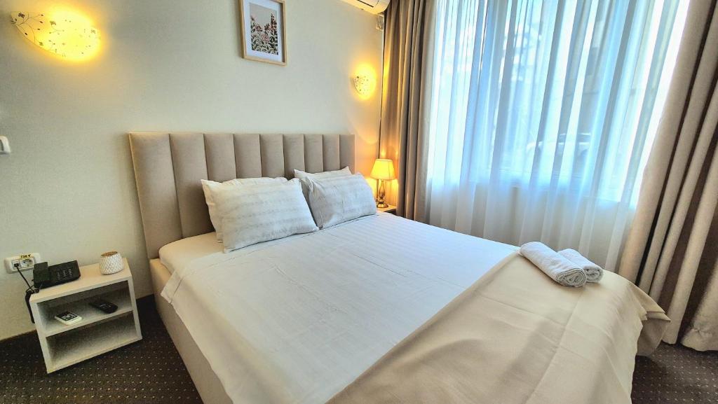 Postel nebo postele na pokoji v ubytování Hotel Marie