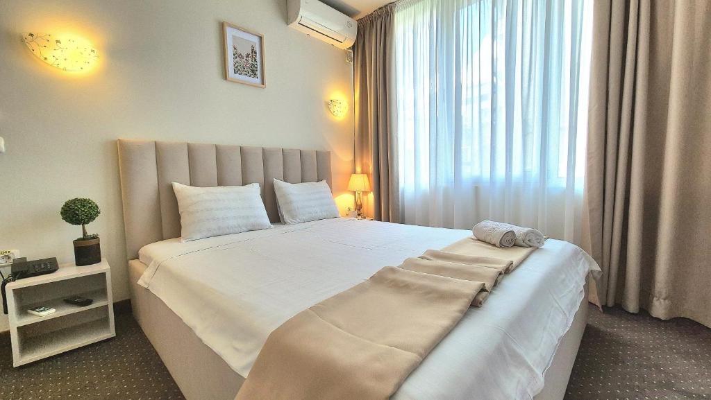 Postel nebo postele na pokoji v ubytování Hotel Marie