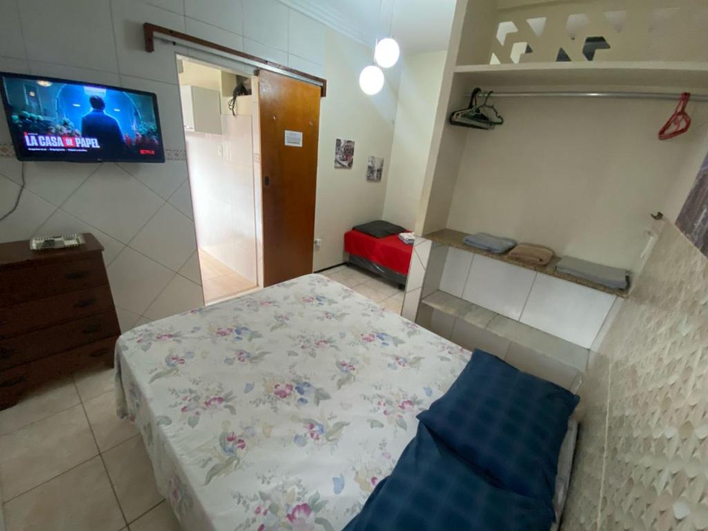 a small bedroom with a bed and a television at Residence Fonteles in Sobral