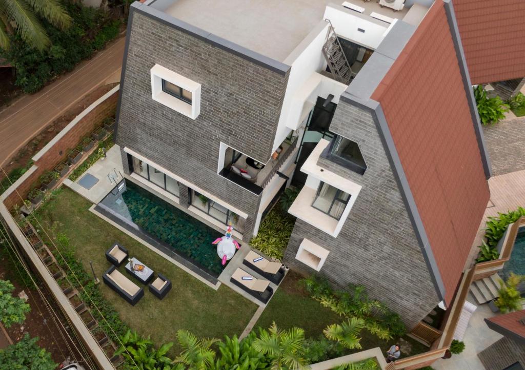 an aerial view of a house with a swimming pool at Villa Reverie By AT Villas in Vagator