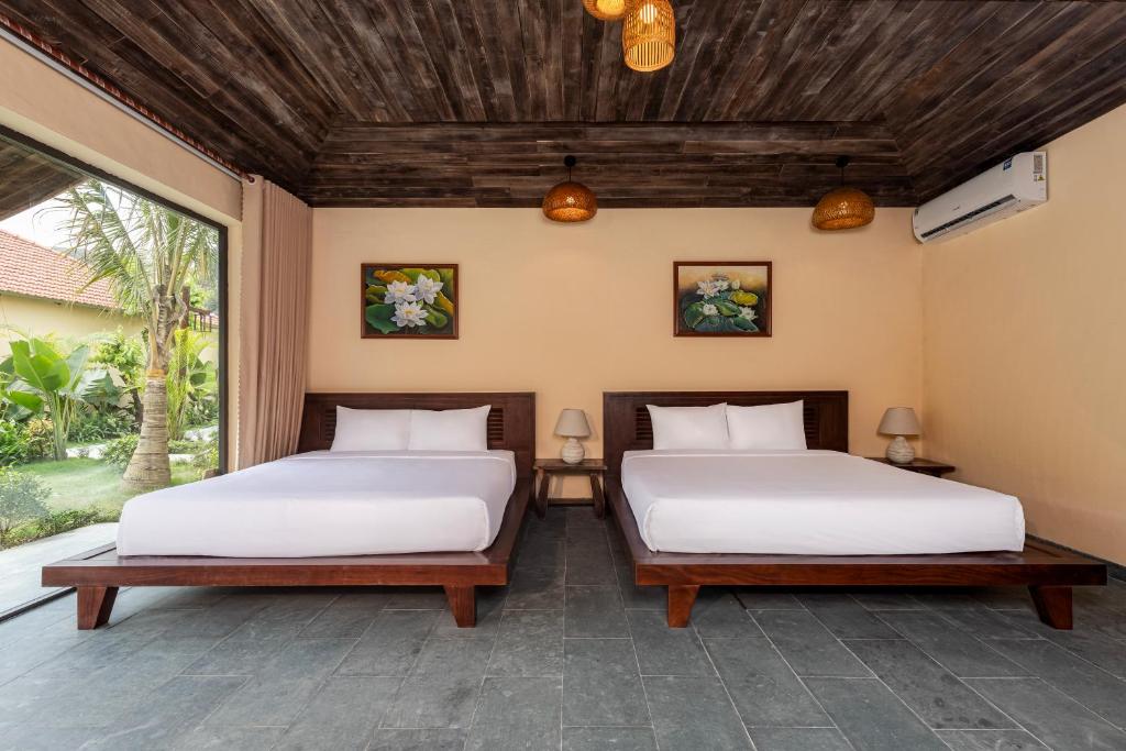 Postel nebo postele na pokoji v ubytování Scenic Mountain Ecolodge Ninh Binh