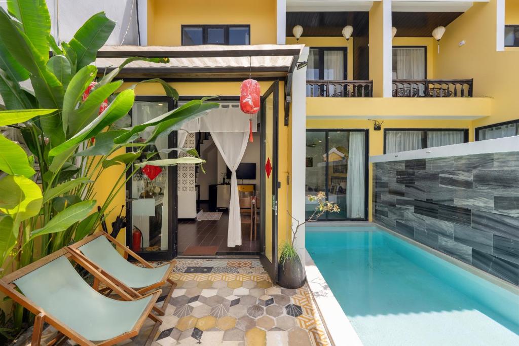 a villa with a swimming pool and a house at Hoi An 2BR private Pool Villa - Walk to Old Town in Hoi An
