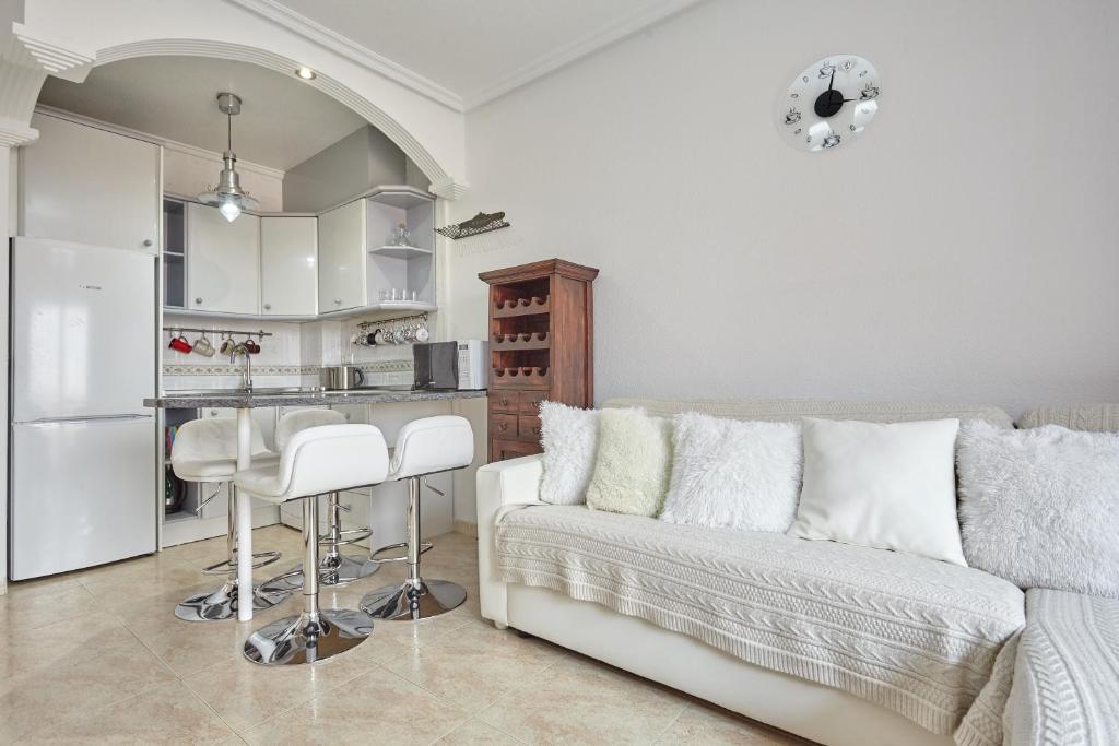 a living room with a couch and a kitchen at Lenas Apartments Pedro Lorca in Torrevieja