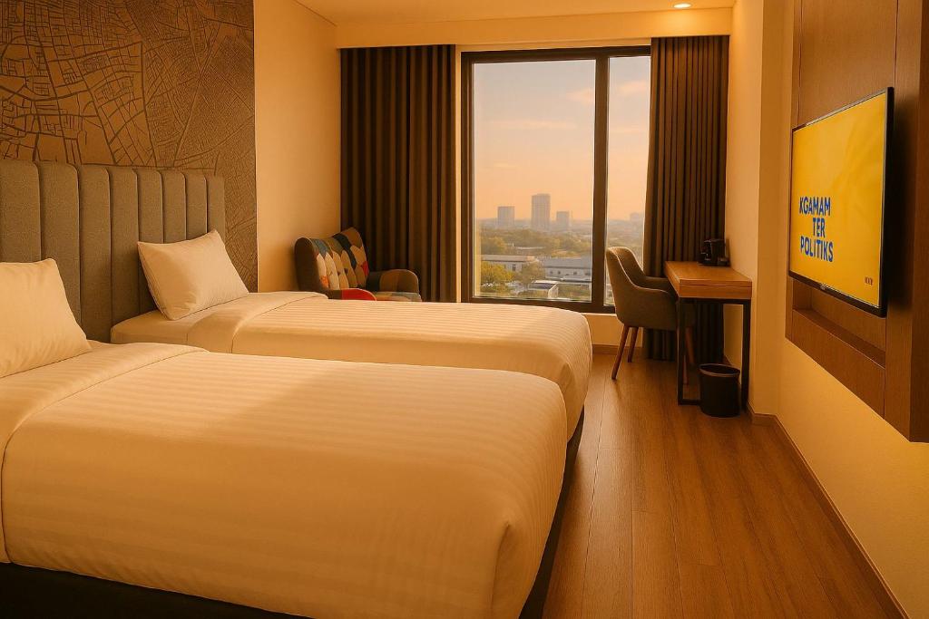 Postel nebo postele na pokoji v ubytování QNZ Hotel Jakarta