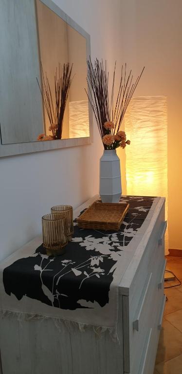a table with a vase on top of it at La Casa di Oli&Cris in Bolsena
