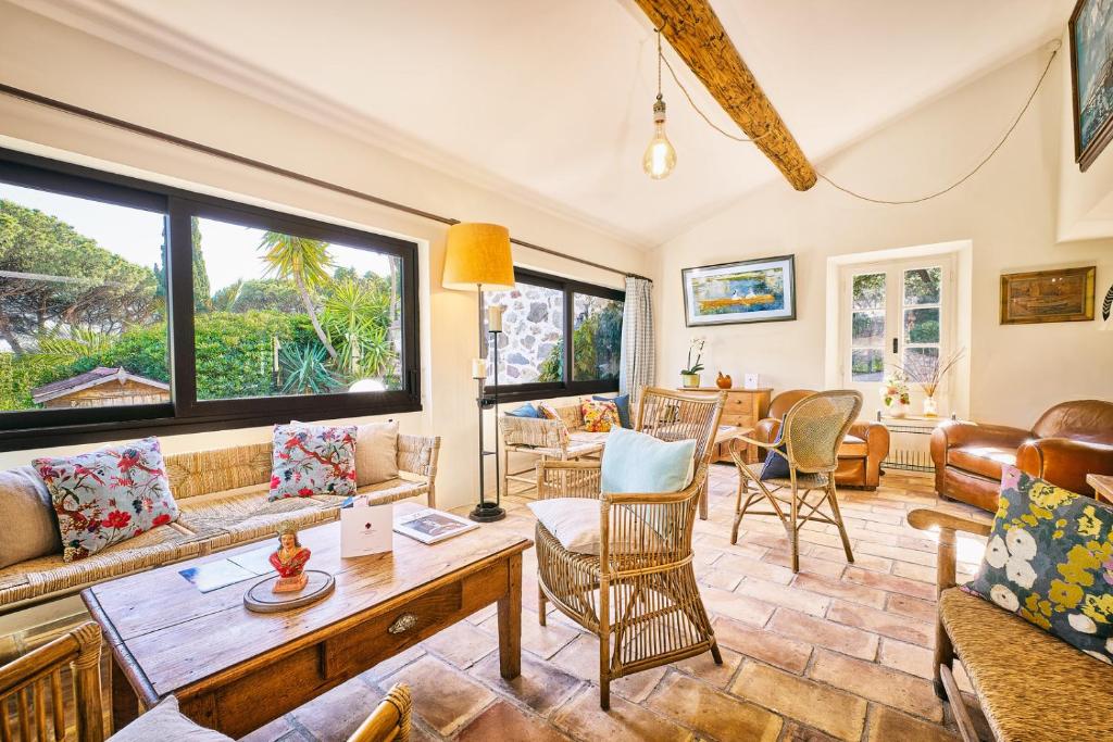 a living room with couches and a table at La Ferme D'Augustin in Saint-Tropez