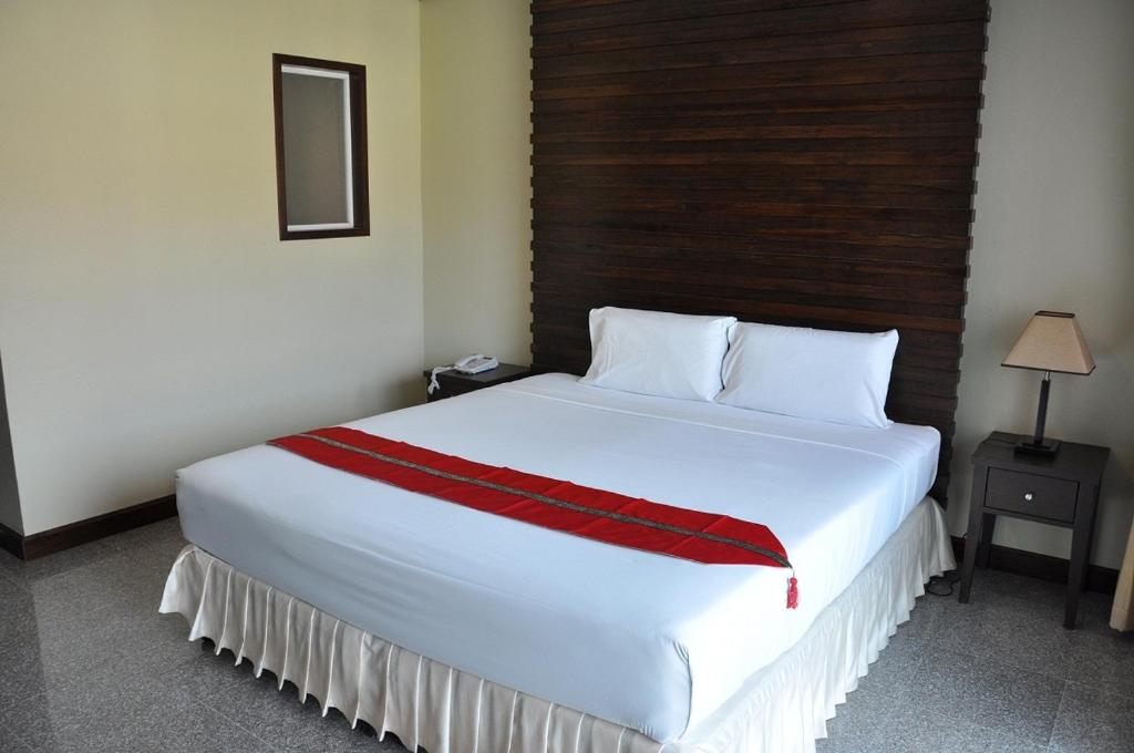 
A bed or beds in a room at Karon Bay Inn
