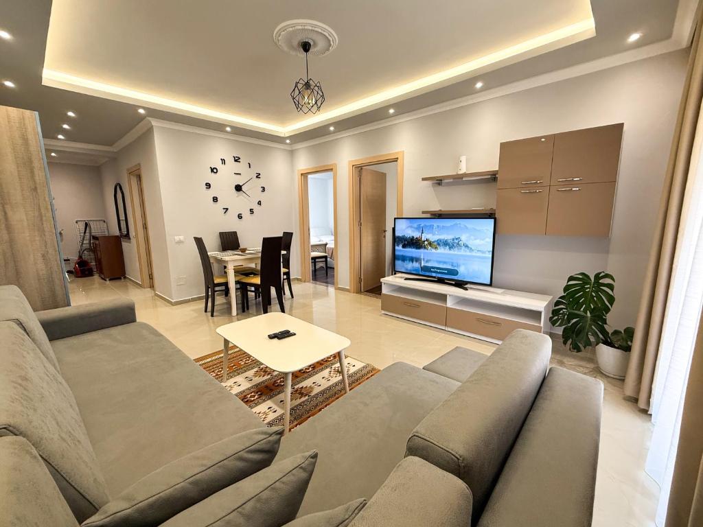 a living room with a couch and a table at Fishta Apartment Q6 37 in Velipojë