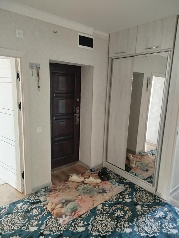 a room with a mirror and a door and a rug at Apartment near to the centre in Nukus