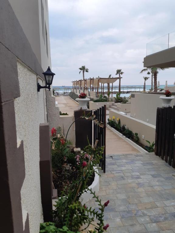 a walkway with flowers on the side of a building at Chrispa's House Beachfront Bliss & Stunning Views 50m from the beach in Rethymno