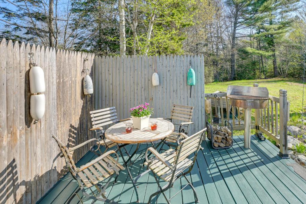 a patio with a table and chairs and a grill at 13 Mi to Acadia Artistic Retreat in Nature in Trenton