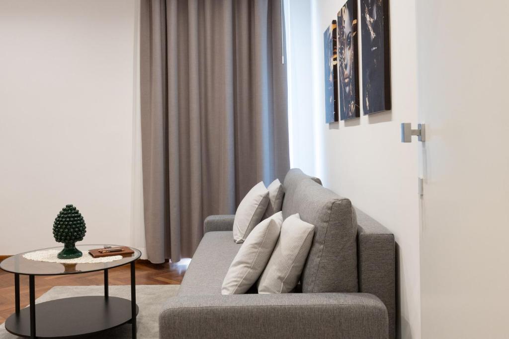 a living room with a couch and a table at Teddy House Ortigia in Syracuse