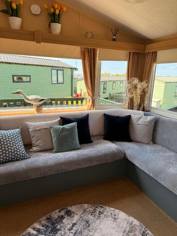 a couch in a living room with a window at Skigh Cabin in St. Andrews